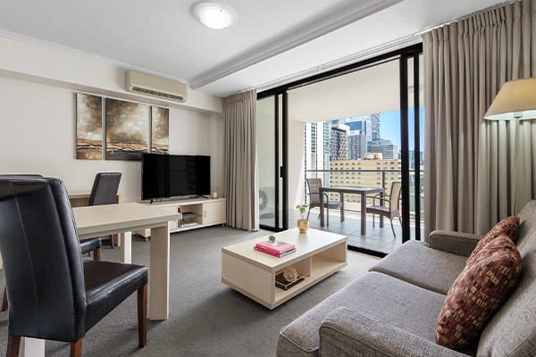 iStay River City one bedroom living connected to a spacious balcony