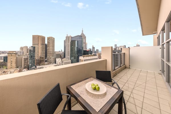 vegetarian breakfast on table on big private balcony of Hotel Apartment with views of Melbourne city at Oaks On Lonsdale street, Victoria, Australia